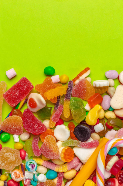 Colorful candies on green background - Photo, Image