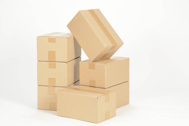unmarked heap of cardboard boxes on white surface - Foto, imagen