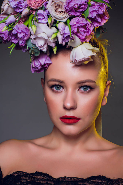 Close-up portrait of a sensual spring lady in a wreath of flowers. Black background. Beauty, cosmetics. Make-up - Fotografie, Obrázek