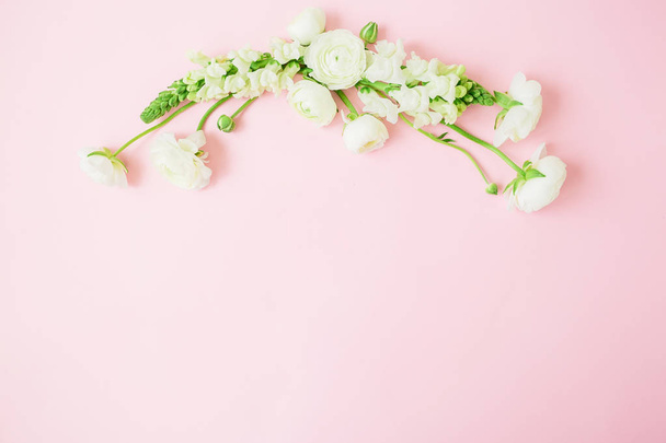 Cadre pastel floral composé de fleurs blanches sur fond rose. Couché à plat, vue de dessus. Fond floral
. - Photo, image