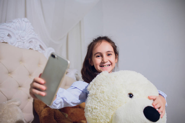 girl treats the bear and make selfie photo. - Фото, зображення