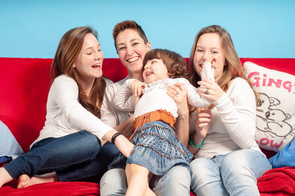 happy mother and children on the couch - Фото, изображение