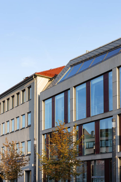 office building with glass window facade on fall afternoon in south germany - Фото, изображение