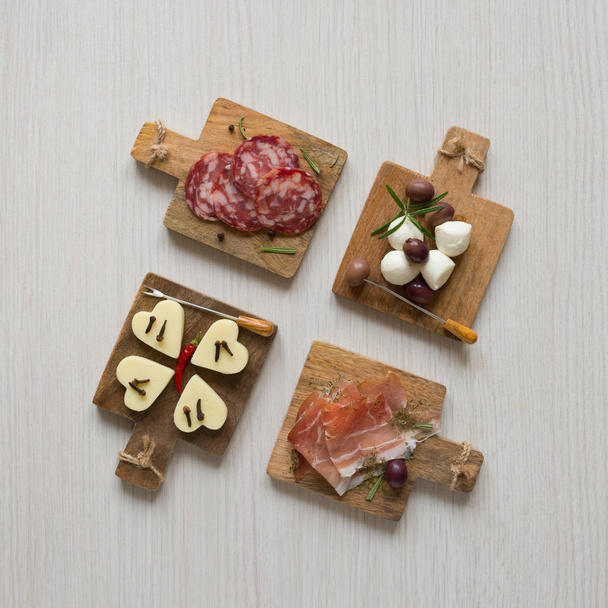 Four mini buffet appetizer with various snack on  chopping board - Fotografie, Obrázek