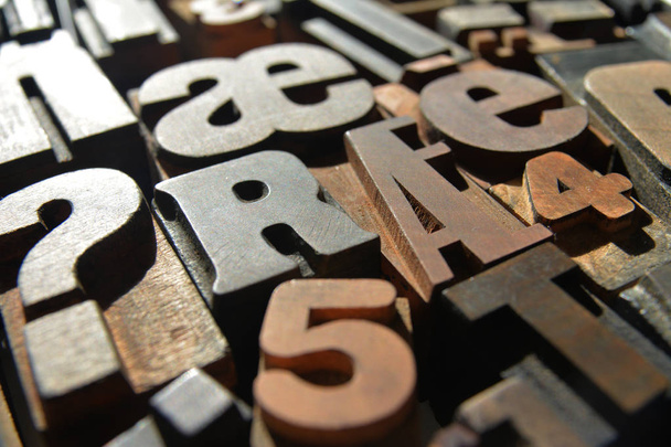 a closeup photograph of a variety of different typefaces in wooden letterpress - Photo, Image