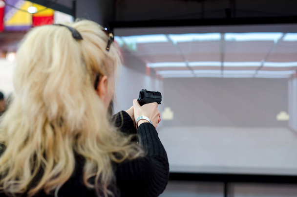 Woman shooting in virtual shooting gallery - Photo, Image