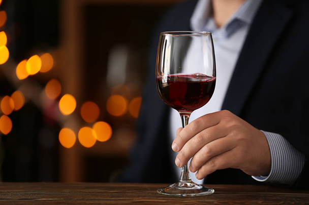 Man with glass of wine in bar - Photo, Image