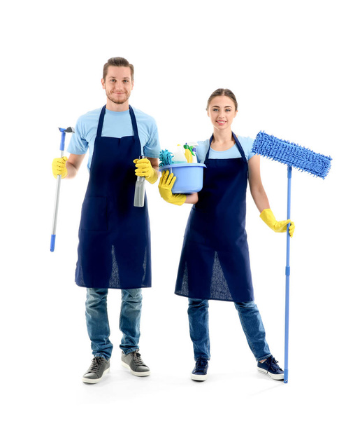 Man and woman with cleaning supplies on white background - Foto, immagini