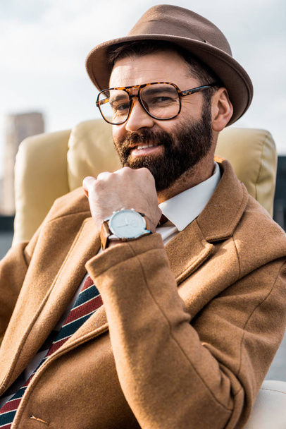 close up of smiling businessman in glasses and hat  - Foto, Imagem