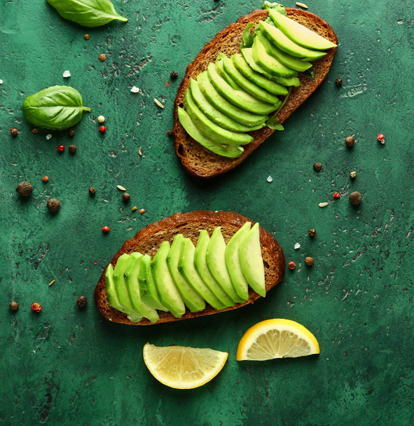 Delicious toasts with avocado on color table, top view - Fotoğraf, Görsel