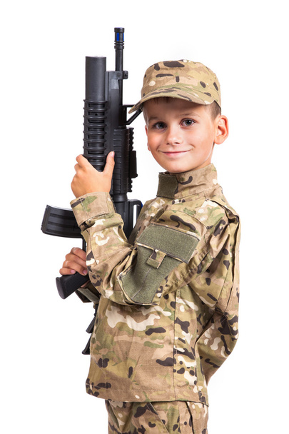 Young boy dressed like a soldier with rifle - Фото, зображення