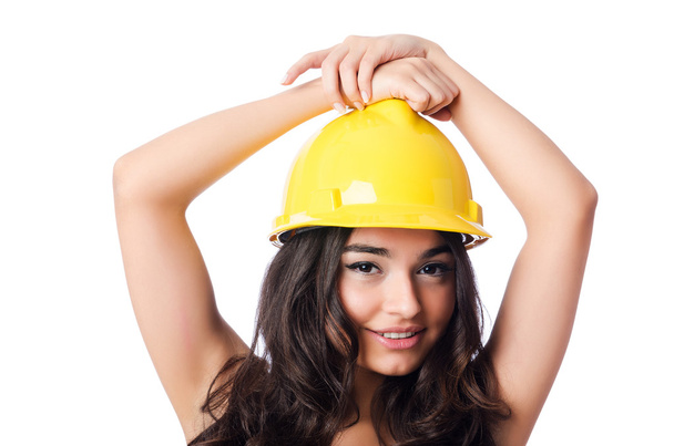 Young woman with hellow hard hat on white - Foto, immagini
