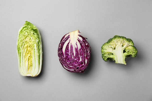 Fresh cabbages on grey background, flat lay - Фото, изображение