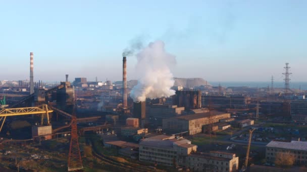 Smoke from a pipe of a metallurgical plant. Evening time. Aerial view - Footage, Video