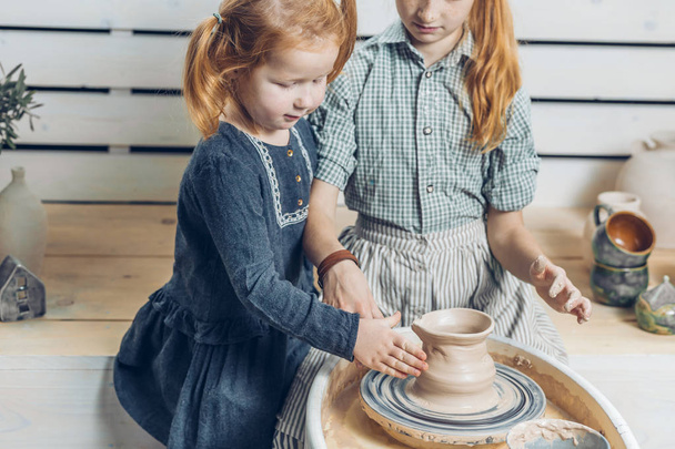 pot creating on the pottery wheel. close up cropped photo.jar making in a traditional way in the studio - Fotografie, Obrázek