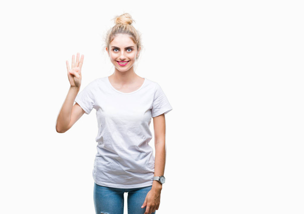Молодая красивая блондинка в белой футболке на изолированном фоне показывает и указывает пальцами номер четыре, улыбаясь уверенно и счастливо
. - Фото, изображение