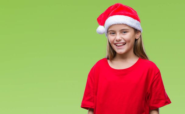 Młoda piękna dziewczyna sobie Boże Narodzenie kapelusz na białym tle szczęśliwy i chłodnym uśmiechem na twarzy. Szczęśliwy człowiek. - Zdjęcie, obraz