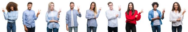 Composition of african american, hispanic and caucasian group of people over isolated white background smiling with happy face winking at the camera doing victory sign. Number two. - Photo, Image