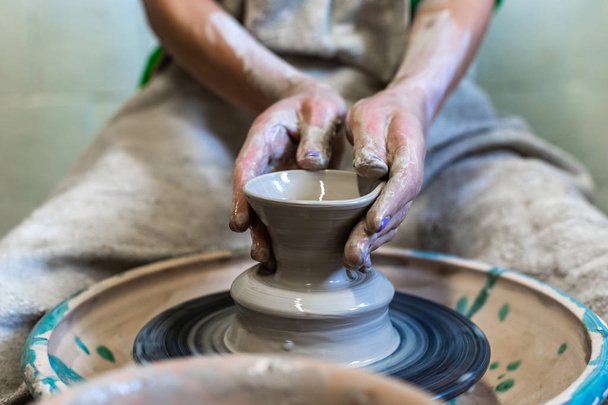 Master class concept. Cropped photo of lady person in her workwear she sit inside workspace make ceramics product for sale by hands - Photo, Image