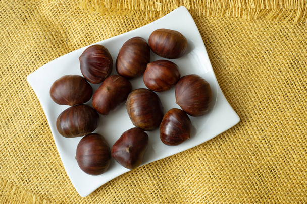Ripe chestnuts close up. Raw Chestnuts for Christmas. Fresh sweet chestnut. - Photo, Image