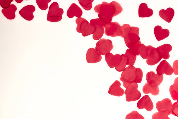 scattered red hearts on a white background. Excellent background to the day of Saint Valentine. - Photo, image