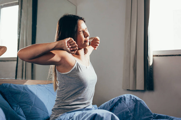 Woman stretching in bed after wake up - Photo, Image