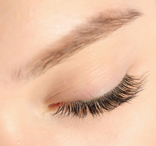 Closeup view of beautiful young woman with eyelash extensions - Photo, image