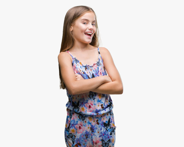 Young beautiful girl wearing colorful dress over isolated background happy face smiling with crossed arms looking at the camera. Positive person. - Foto, Bild