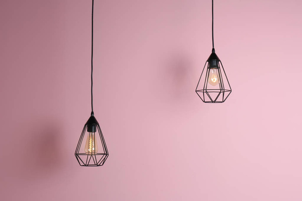 Modern hanging lamp on color background. Idea for interior design - Foto, Imagem