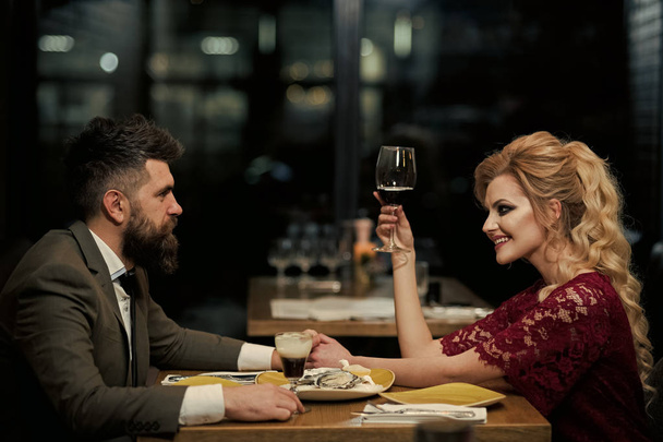 Attractive Caucasian couple flirting indoor with oysters and wine - Фото, зображення