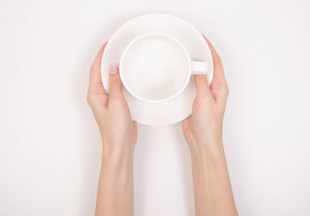 White saucer cup in hand - 写真・画像