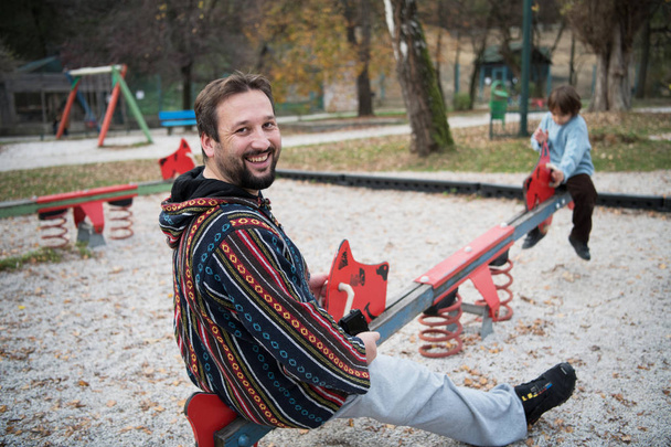 father and  child having fun together  in park playground happy family concept - Фото, изображение