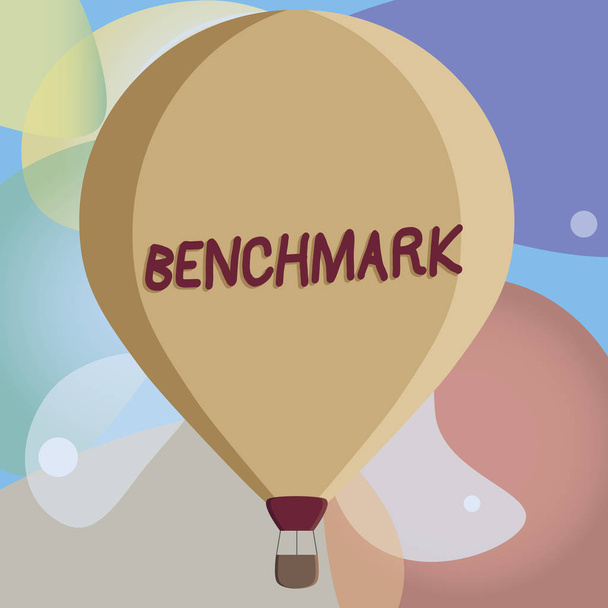 Conceptual hand writing showing Benchmark. Business photo text standard or point of reference against which things compared Color Hot Air Balloon afloat with Basket Tied Hanging under. - Photo, Image