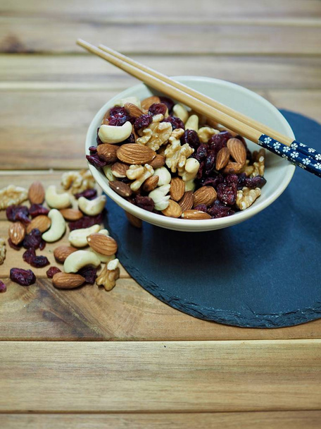 Nut mix, almonds, walnuts, cashew nuts, raspberries - Photo, Image