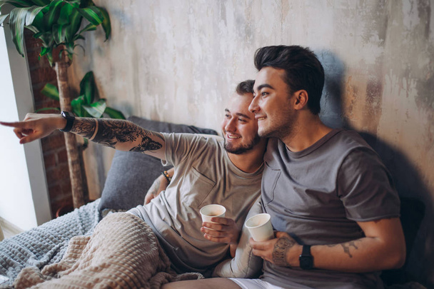 Perfect morning begins with lover and coffee in bed. Two guys resting in bed. - Fotoğraf, Görsel