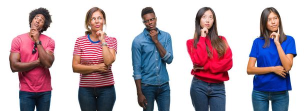 Composition of african american, hispanic and chinese group of people over isolated white background with hand on chin thinking about question, pensive expression. Smiling with thoughtful face. Doubt concept. - Photo, Image