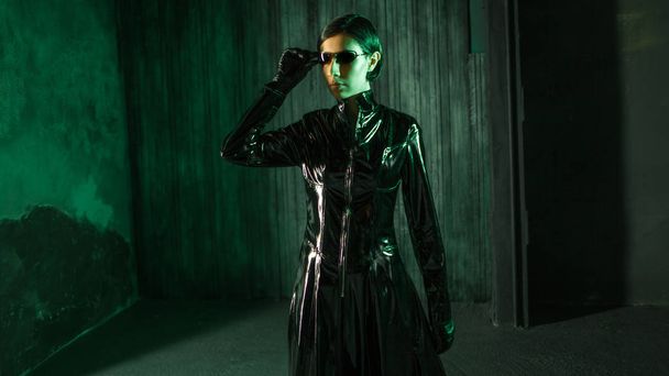 Girl hacker in the digital world. Young woman in matrix style suit. - Foto, Bild
