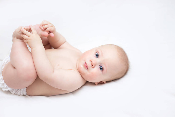 cute infant lying on a changing table at home - Photo, Image