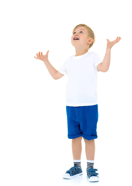 A little boy in a white T-shirt. - Фото, изображение
