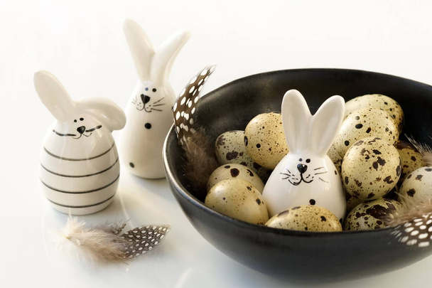 quail eggs easter in a bowl and Easter bunny on white background. copy space - Fotoğraf, Görsel