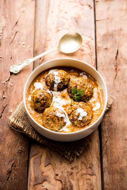 Malai Kofta is a Mughlai Speciality dish served in a bowl or pan over moody background. selective focus - Photo, Image