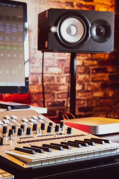 recording studio equipment. computer, midi keyboard synthesizer, loudspeakers, mixing console - Фото, изображение