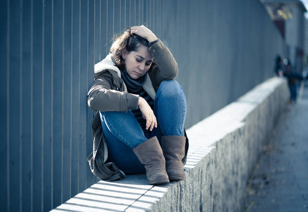 Young adult felling shame depressed and hopeless sitting alone in city urban street in Depression Loneliness Mental health Emotional pain Social violence Abusive relationship and Harassment concept. - Photo, Image