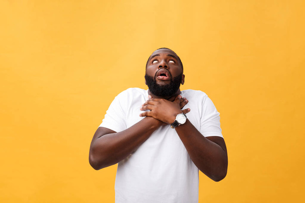 Portrait of african american man with hands raised in shock and disbelief. Isolated over yellow background. - Φωτογραφία, εικόνα