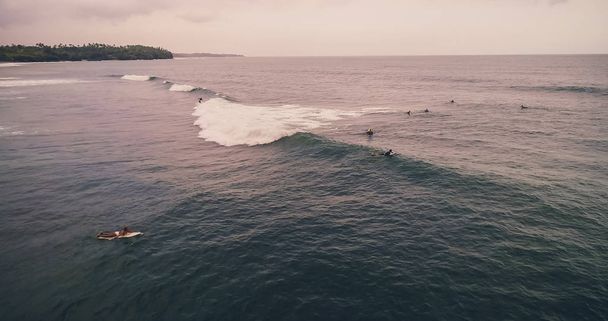 Aerial view surfers and wave in tropical ocean. Top view - Foto, Imagem