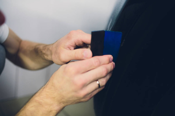 Worker hands installs car paint protection film - Foto, Imagen