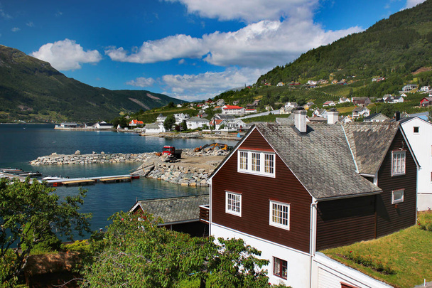 Ullensvang, Norway - June 22, 2018: View of Ullensvang village at the Hardanger fjord, Hordaland county. The place is famous for its mild climate and fruit and berries gardens. - Fotografie, Obrázek