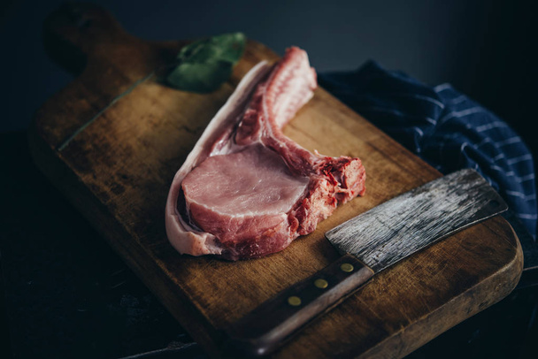A pork chop on a wooden board - Fotoğraf, Görsel