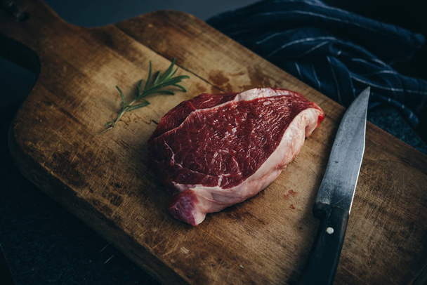 A piece of beef sirloin steak on a wooden board - Φωτογραφία, εικόνα
