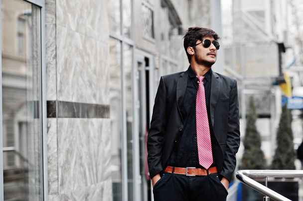 Young indian man on suit, tie and sunglasses posed outdoor. - 写真・画像